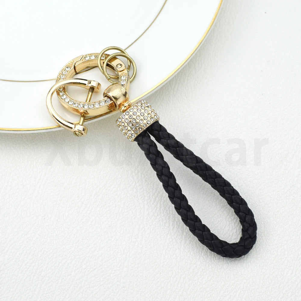 Gold and diamond-encrusted TPU key fob cover with a black cord strap
