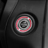 Close-up of a black car button featuring a circular crystal rhinestone start and stop mechanism.