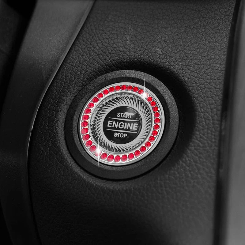 Close-up of a black car button featuring a circular crystal rhinestone start and stop mechanism.