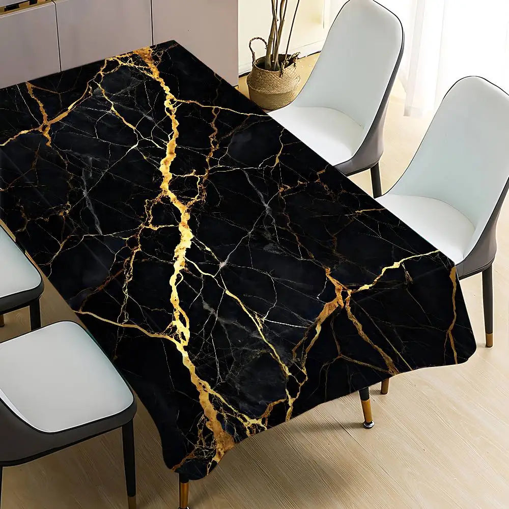 Black gold marble waterproof tablecloth spread over a dining table with white chairs.