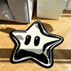 A black and white irregular pentagram rug placed on a wooden floor.