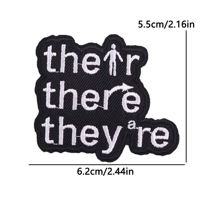 Black embroidered iron-on letter and word patches spelling out the phrase there they are
