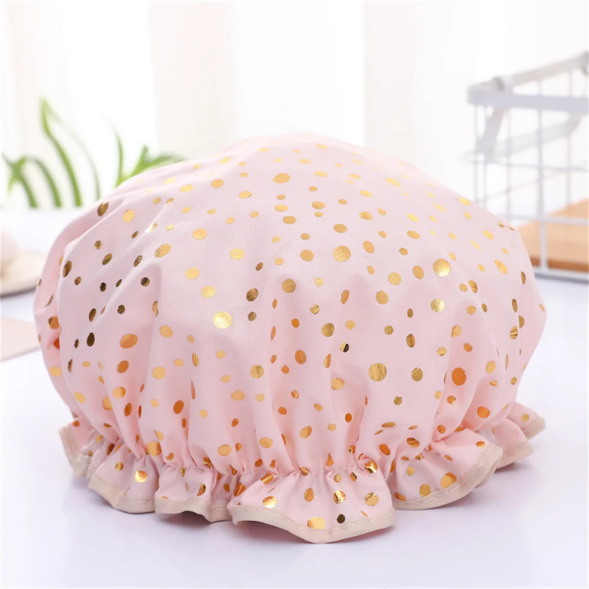 Pink reusable elastic shower cap for women with gold polka dots