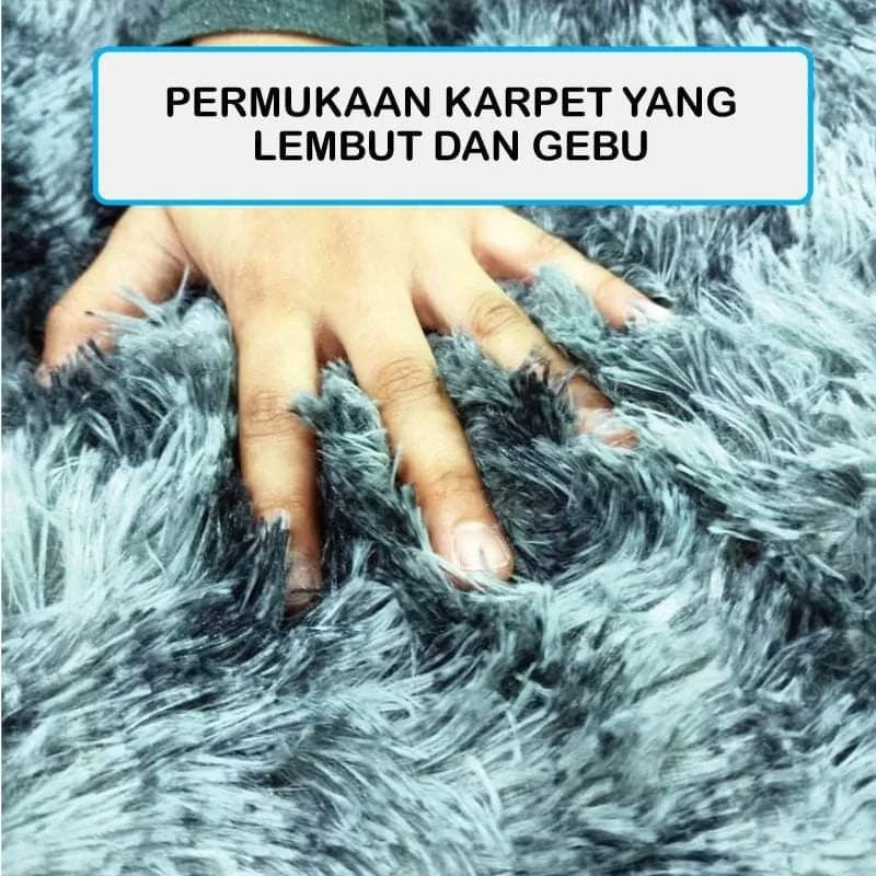 A hand is touching a fluffy, gray carpet texture.