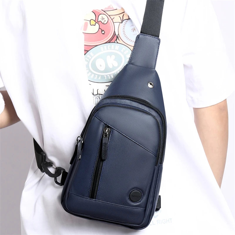 Navy blue men's adjustable crossbody chest bag worn by a person.
