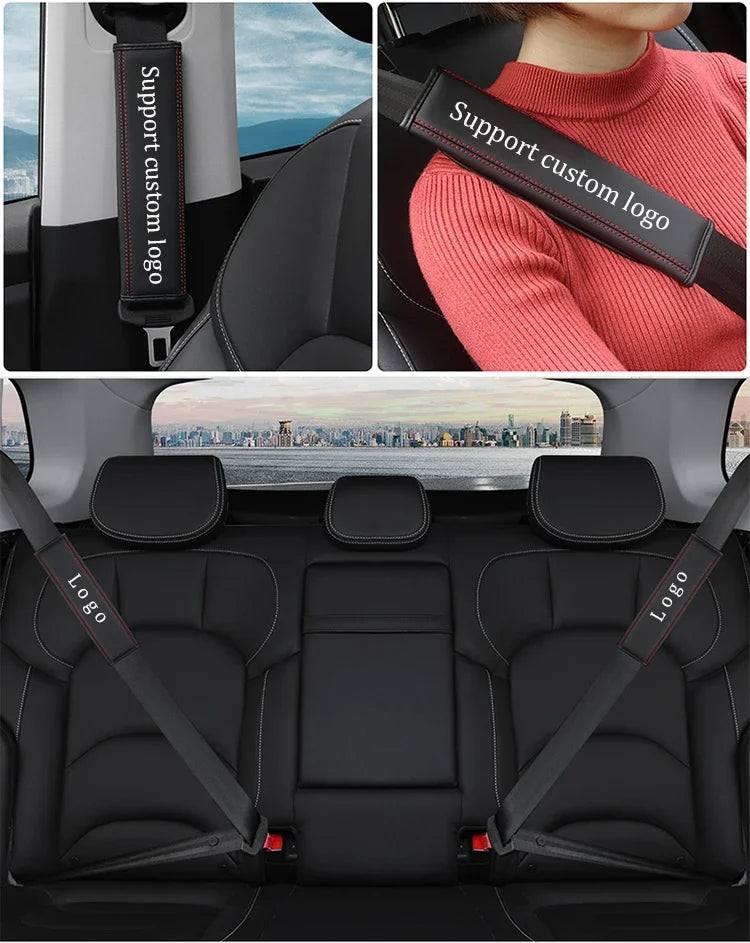 Black leather seat belt covers with custom logo accents installed in a car interior.