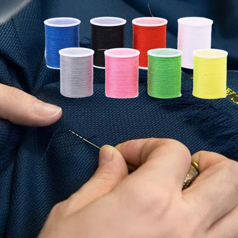 A hand is shown sewing a brightly colored thread onto a fabric, with several spools of various colors laid out.