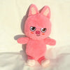 A pink, fluffy plush doll shaped like a pig with large ears and cute facial features.