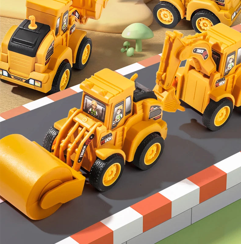 A set of yellow diecast construction vehicles, including a push-play excavator and bulldozer, displayed on a gray surface.