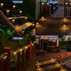 Various outdoor lighting installations including fence lights, step lights, deck lights, and stair lights on wooden paths.