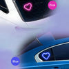 A close-up view of a blue car with pink and blue ambient heart lights visible on the grille and body.
