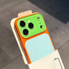 A color blocking shockproof phone case featuring a large camera window with green and orange accents.