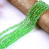 Green faceted crystal glass spacer beads strung on a brown twine.