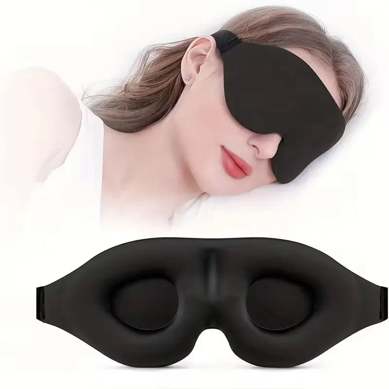 A black 3D contoured silk-touch sleep mask is shown being worn by a person, with the product lying flat below.