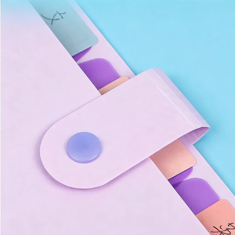 A stack of purple and pink accordion document folders for A4 papers on a light blue background.