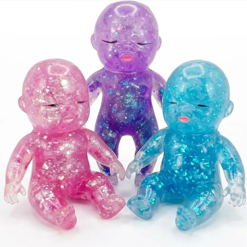 Three glitter squishy silicone figures in pink, purple, and blue for stress relief and fidgeting