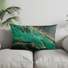 A decorative pillowcase featuring a modern geometric pattern of teal and gold marbled lines.