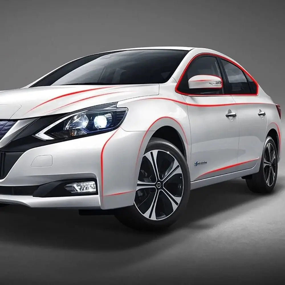 A white sedan with red protective strips on the body and bumper, shown in a studio setting.