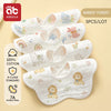 A set of five white cotton muslin bandana bibs featuring cute animal designs for babies