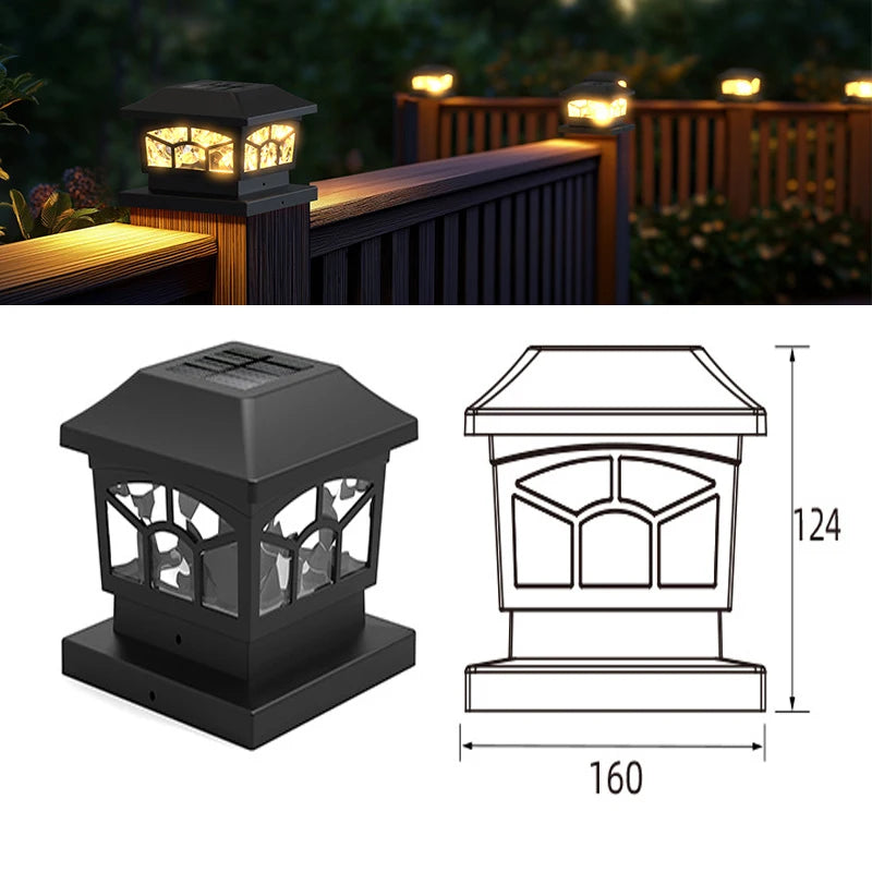 A black solar post cap light fixture with a warm LED illuminates a wooden fence or deck.