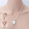 A white leather cord necklace with a silver cross pendant displayed on a mannequin neck.