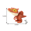 A small, reddish-orange interactive finger biting dinosaur toy featuring a Triceratops or Tyrannosaurus head and body.