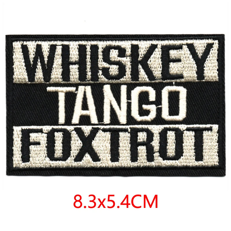 Black embroidered iron-on letter patches with white text reading Whiskey Tango and Foxtrot