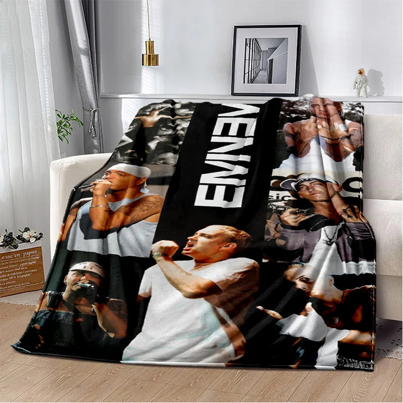 A black and white throw blanket featuring images of Eminem and 2Pac hip-hop icons.