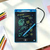 A blue portable LCD drawing tablet displaying a starry theme with various space-related icons and a stylus on a white table.