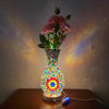 A handcrafted Turkish mosaic table lamp with a warm LED glow featuring colorful glass and floral elements.