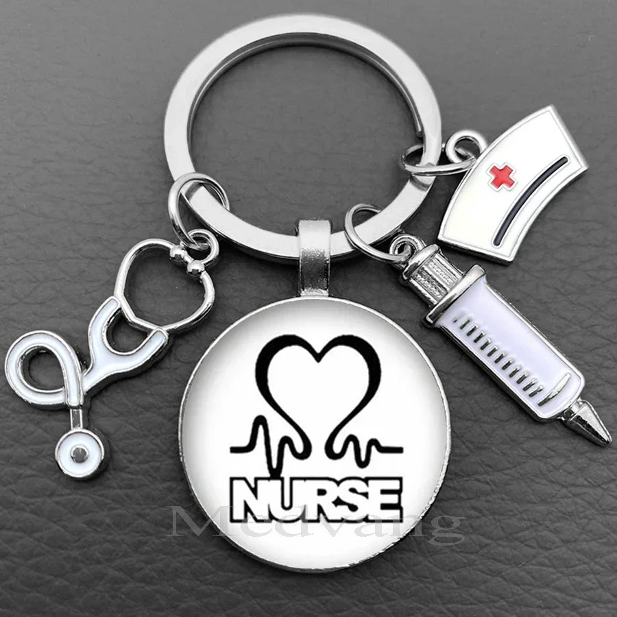 Silver keychain featuring a heart and the word NURSE design with a medical symbol and a glass dome charm.