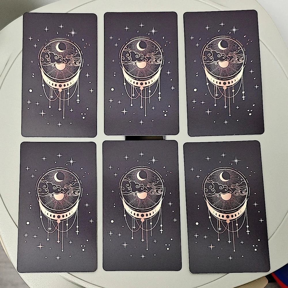 Ein Set von neun dunkelgrauen Orakelkarten mit stilisierten Mond- und himmlischen Designs.
