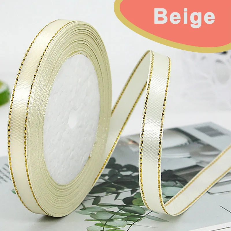 Roll of beige gold-edge satin ribbon for crafts and gift wrapping