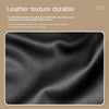Close-up texture of black leather material showing a fine grain pattern.