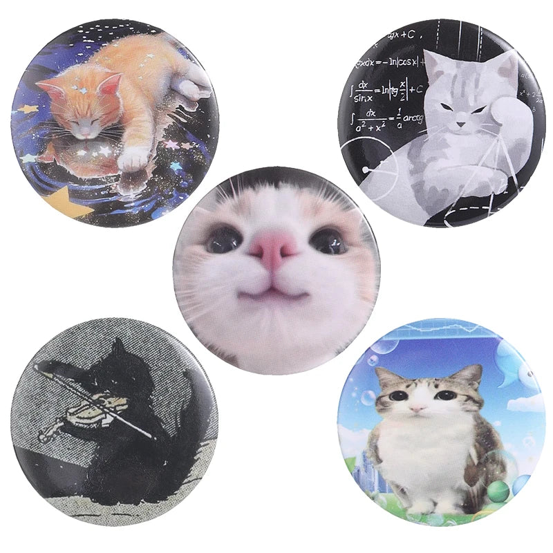 A set of five tinplate pins featuring various cats in different poses and styles.