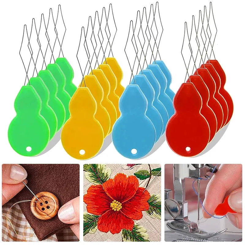 A set of colorful plastic needle threaders in green, yellow, blue, and red, alongside a wooden needle and a red flower.