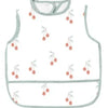A white waterproof full-body baby feeding bib with a sleeveless design and light gray trim.