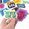 A hand holds a purple embroidered patch that says Have a Great Day