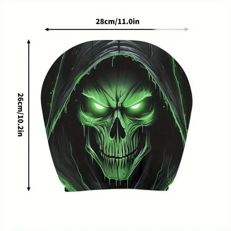 A black cartoon skull design with glowing green eyes on a headrest cover.