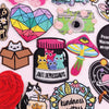 A collection of colorful cartoon cat embroidery patches and iron-on designs featuring various expressions and themes.
