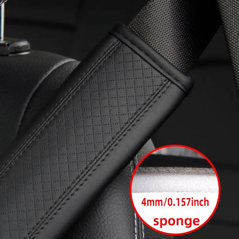 Close-up of a black PU leather embossed seat belt shoulder cushion with a sponge layer.