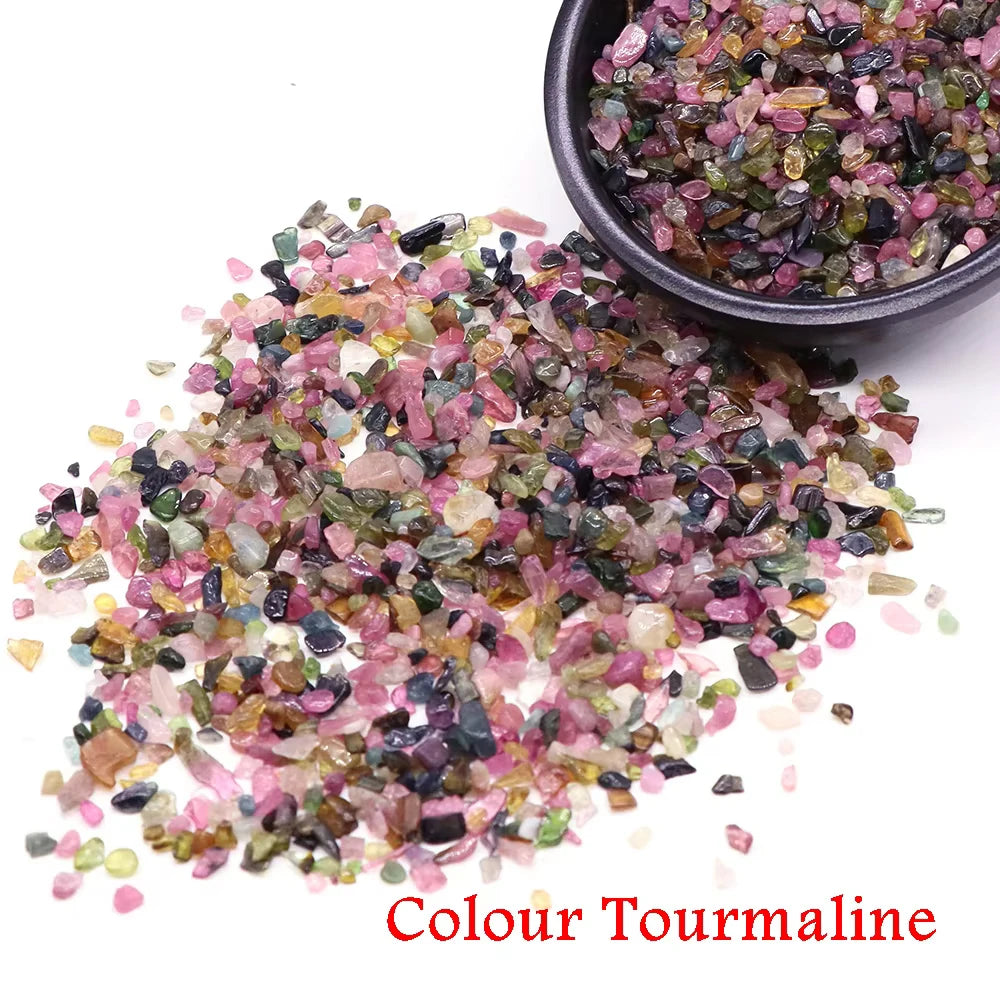 A pile of colorful tourmaline crystal stone chips in various shades and sizes.