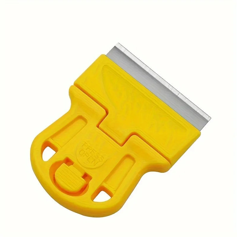 A yellow compact multi-purpose scraper with a metal blade for removing stickers, glue, and paint.
