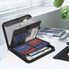 A black fireproof waterproof document organizer bag is open, showing multiple compartments for passports and documents on a w