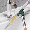 A silicone scraper broom and squeegee is shown pouring water from a faucet into a sink basin.