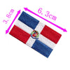Embroidered patch of the Dominican Republic flag featuring red, white, and blue stripes and a central emblem.