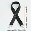 Black adjustable nylon bag strap with a gold buckle shown flat