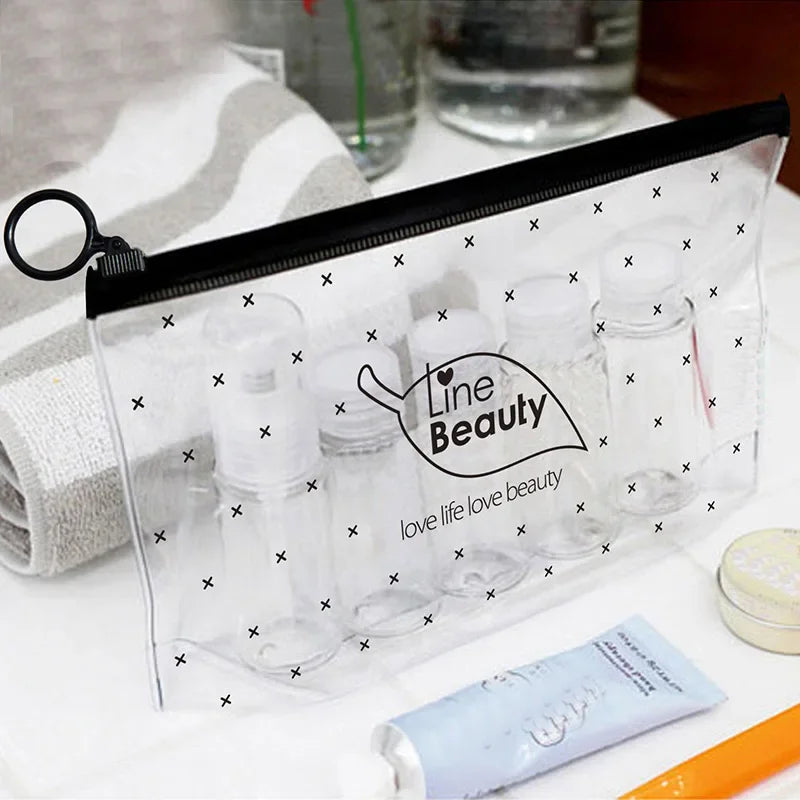 A clear travel toiletry bag with a black hook and multiple glass bottles for toiletries is displayed on a white surface.