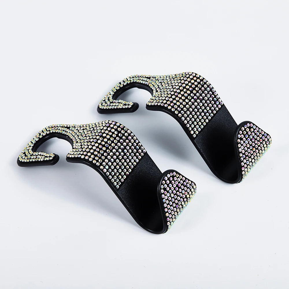 A set of black car seat storage hooks decorated with crystal and diamond accents.