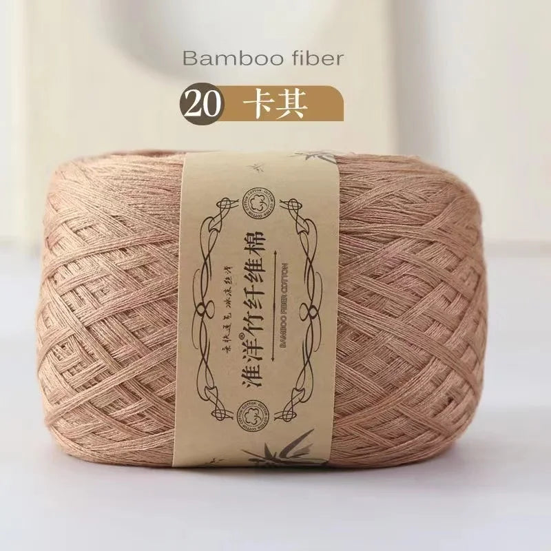 A ball of bamboo fiber yarn, light beige in color, is shown on a white surface.